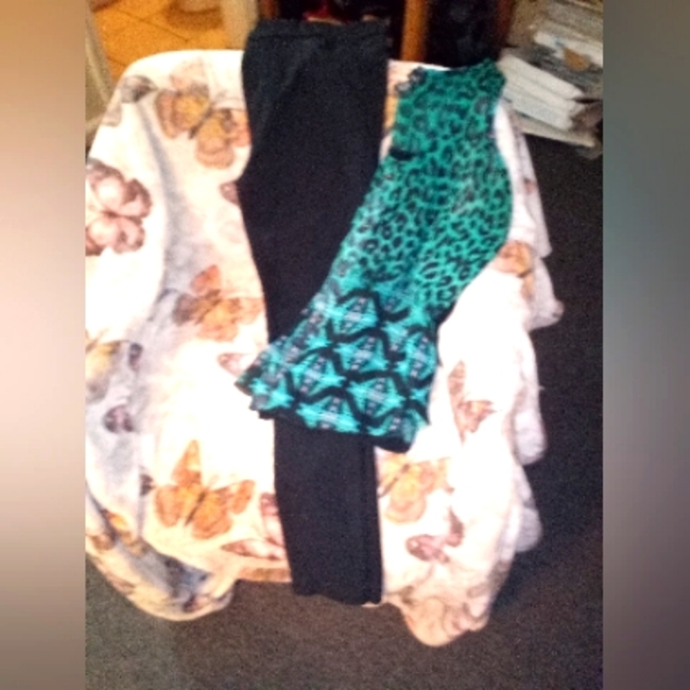 Black pair of women's jeans and a black and turquois shirt